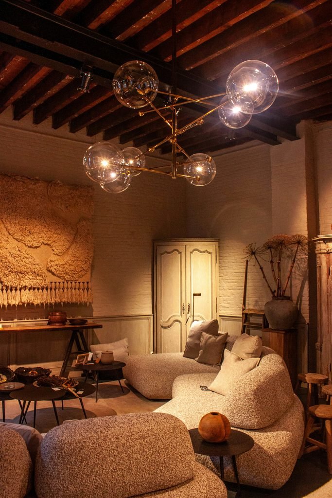 Elegant living room with a large statement chandelier and plush sofa