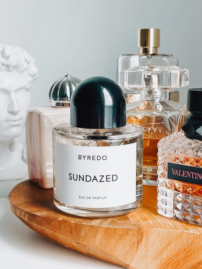 Luxury perfume bottles styled on a wooden tray as elegant vanity decor