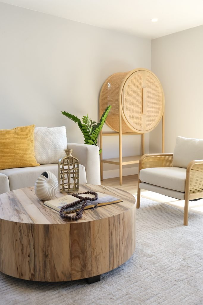 Warm neutral living room with light wood, soft fabrics, ceramics, and natural textures