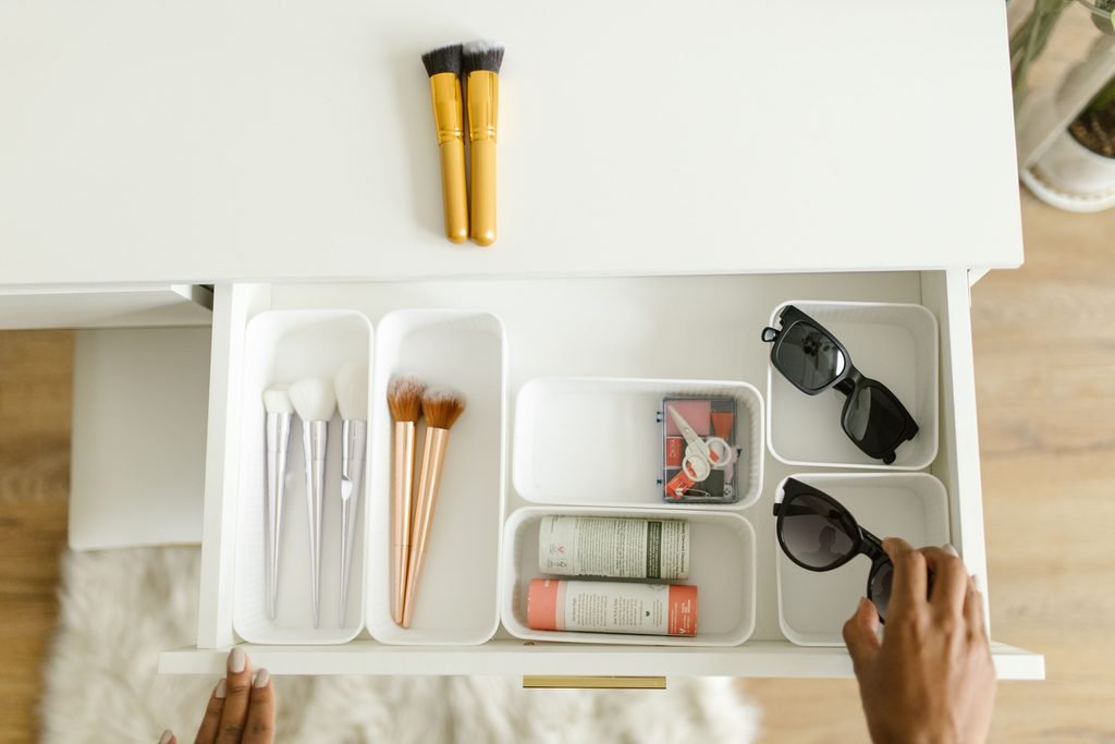Organized vanity drawer with makeup brushes, skincare, and beauty accessories