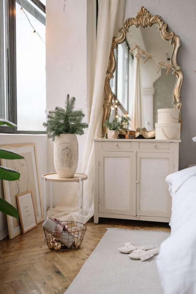 Elegant vanity with a gold mirror and soft feminine bedroom decor